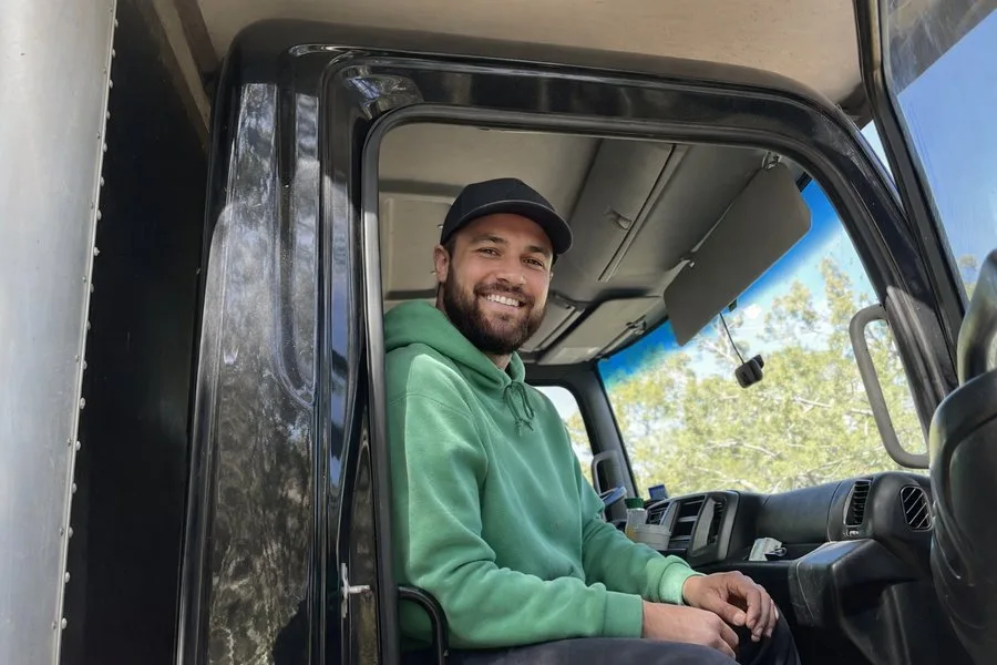 Next Phase Moving crew member keeping the customer updated from the truck