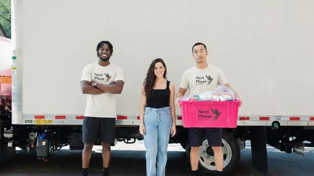 Next Phase Moving crew with a happy client