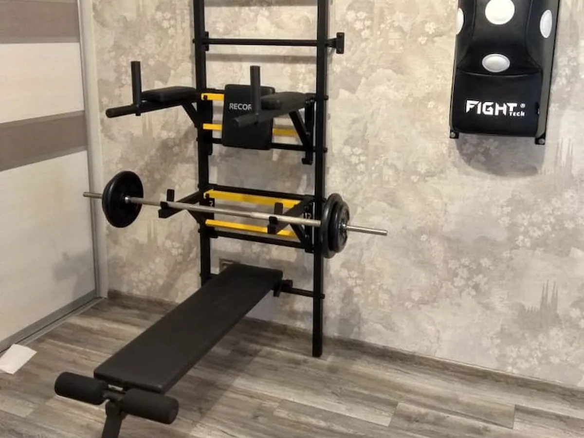 Home gym rack, barbell and bench assembled and set up in a customer's room