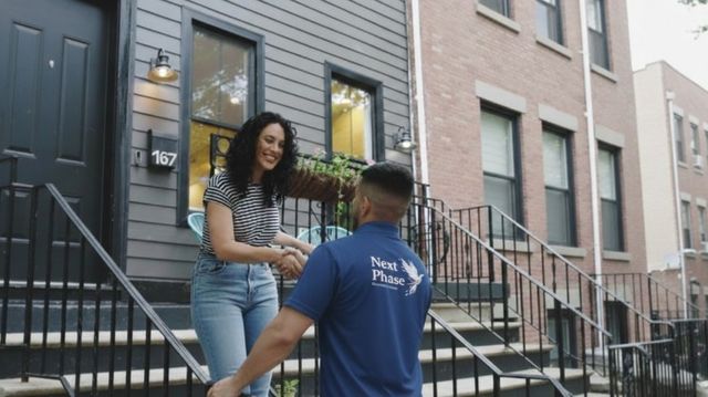 Next Phase mover greeting a happy customer at the door